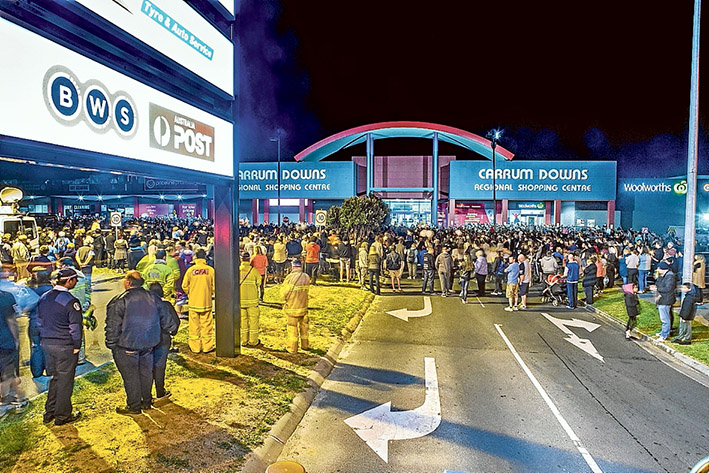 Tributes after tragedy: The community rallied round to show support for the Lehane family in the wake of Andrea Lehane’s death by laying flowers, above, and attending a vigil, above left, at Carrum Downs Regional Shopping Centre. Pictures: Gary Sissons
