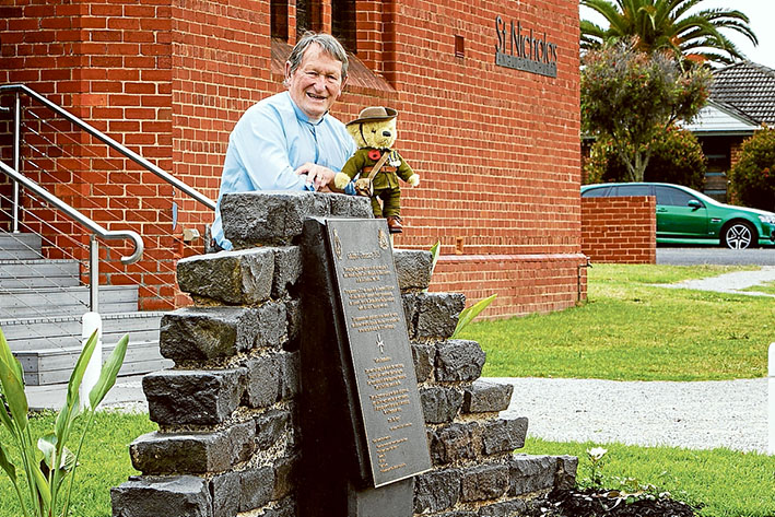 Solid foundation for commemoration: Rev Victor Haste at the Mordialloc Community Gallipoli Precinct at St Nicholas Anglican Church. The bear is named after Clarence Thomas, a 9th Battalion medic who did not carry weapons at Gallipoli. Picture: Gary Sissons