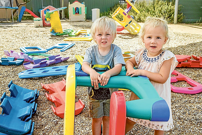Playtime ruined: Jaiden and Daisy at Patterson Lakes Community Centre after a playground was trashed during a weekend party. Bottles and rubbish was cleaned up quickly for safety reasons. Picture: Gary Sissons