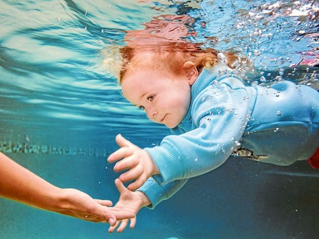 Helping hand: Molly Howarth, 2, above, learns swimming survival skills with Anastasia Monakhov, below, and Nik Monakhov, 2. Pictures: Gary Sissons