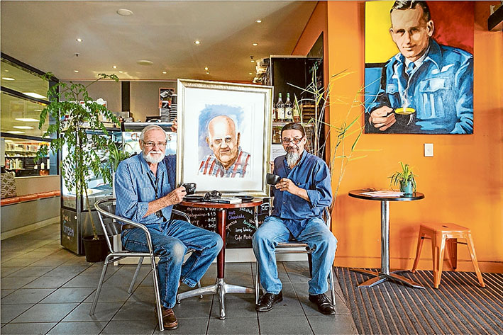 Peace time: Artist Jeff Gilmour, left, and Yvens De Camargo catch up for a cuppa at Charlwood Cafe named in honour of World War II veteran and author Don Charlwood. Picture: Gary Sissons