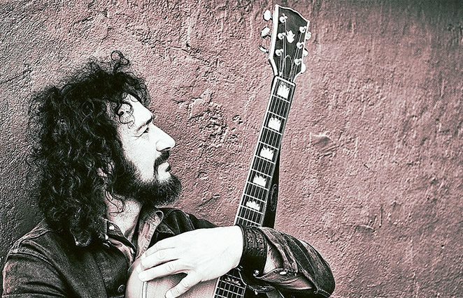 ‘Cat’ cradles guitar: Ron Vincent is bringing his Cat Stevens tribute show to Sorrento’s Spiegeltent later this month. Picture: Yanni
