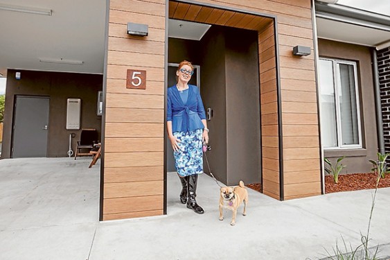 Door to new life: Amanda Worswick and her dog Sally are the first new residents of a TAC secured units complex for crash survivors with ongoing injuries. Picture: Yanni