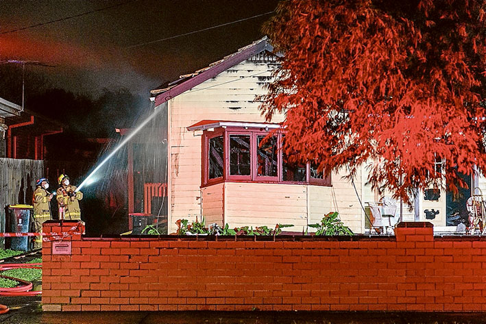 In the heat of the night: Fire crews battle the Powlett St fire but the weatherboard house was destroyed. Pictures: Gary Sissons