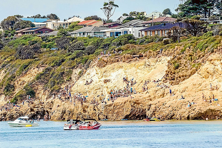 Crowds on the cliffs at The Pillars last summer.