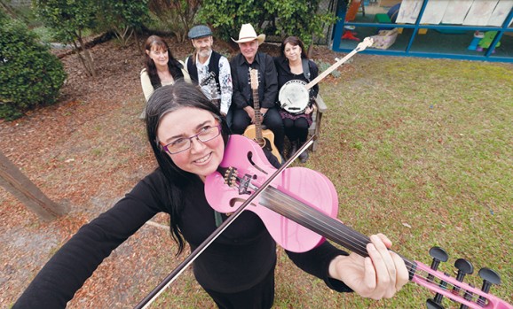 Instrumental as anything: Violinist Sally Carter (front) and (seated from left) Kath Walker of Chovies, Jamez Harrison, The James Gang’s John James and mandolin player Pam James get ready to be on song at July’s Big As Texas concert. Picture: Yanni