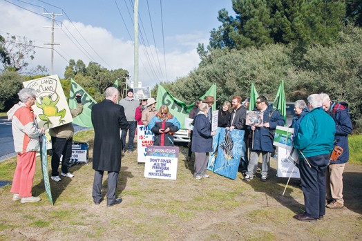 Civil protest: Harcourts real estate agent Michael Spring (third from left) addressed environmental protesters at an auction for a slice of Langwarrin land at McClelland Drive located in Frankston’s Green Wedge. Picture: Gary Sissons