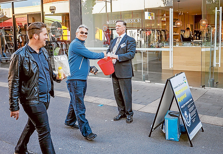 Taking it to the streets: Frankston councillor Glenn Aitken accepts generous donations from Frankston residents in support of a trial project to provide low-cost rental homes to the homeless. Picture: Yanni
