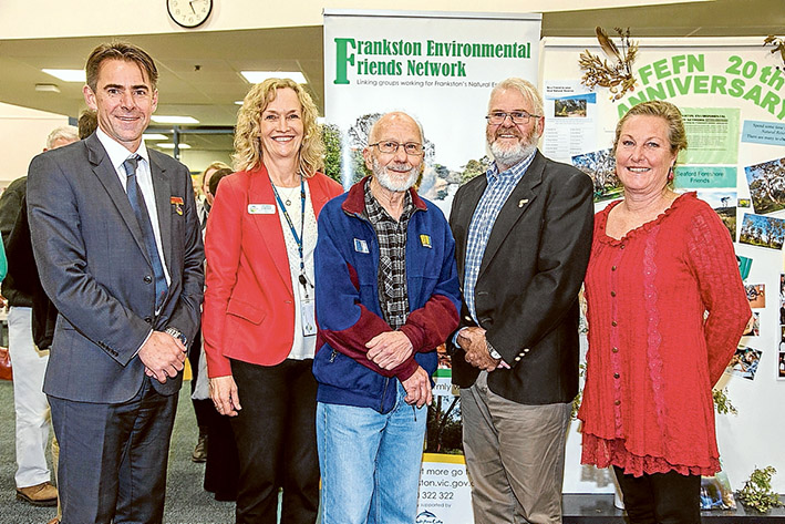 Green team: Frankston mayor James Dooley, left, council environment education officer Debbie Coffey, Friends of Langwarrin Flora and Fauna Reserve’s Leon Costermans, FEFN chair David Cross and Friends of Seaford Foreshore’s Alison Kuiter at the launch of an exhibition at Frankston Library celebrating the 20th anniversary of the Frankston Environmental Friends Network. Pic: Gary Sissons