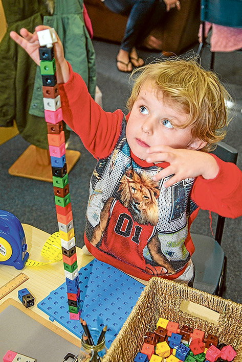 Building blocks to maths success: Chase, 4, built a tower then used a tape measure to work out its height. Picture: Gary Sissons