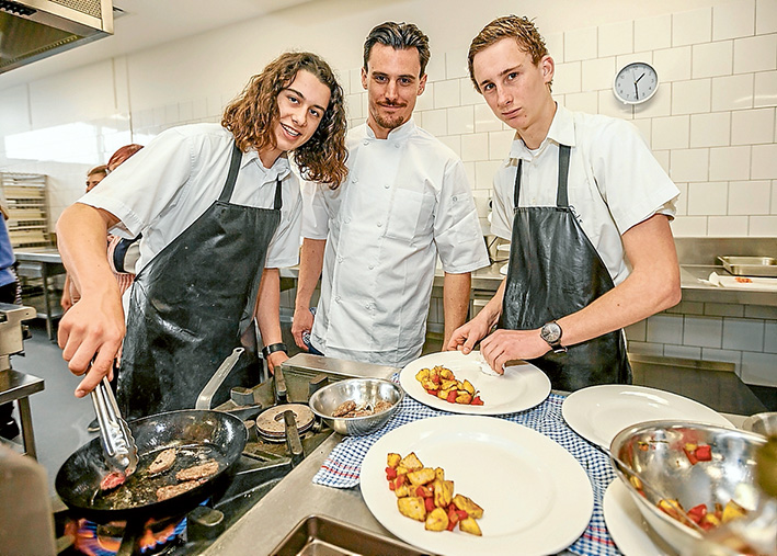 Tongs time: Mornington Padua students Mat Elvey, left, and Will Faska, right, learn under the tutelage of renowned chef Guy Stanaway from Willow Creek. Picture: Yanni