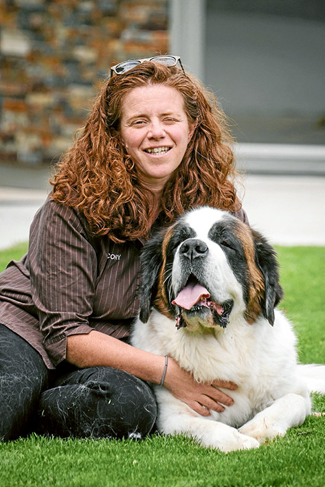 Luxury down pat: Cory Andrews with her dog, a Saint Bernard called Millie, at the Dog Country Club and Kennel Resort. Picture: Gary Sissons