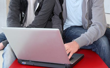 Teenage boys looking at a laptop computer