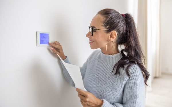 Woman adjusting heating