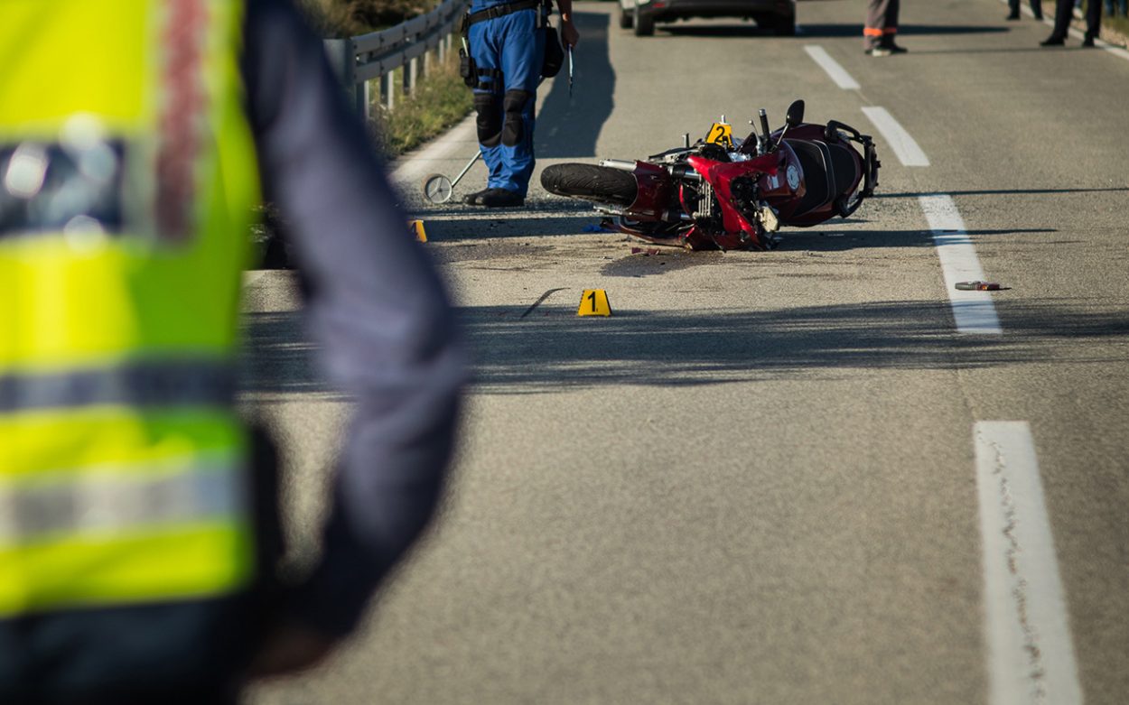 motorcycle crash scene on an open road